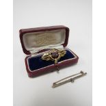 A 9ct gold Victorian brooch set with single ruby in fitted case and a diamond set bar brooch (2)