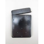 A gun metal card case applied with turquoise studs