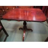 A George III flamed mahogany tilt top wine table,