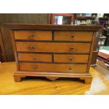 A Georgian style handcrafted miniature chest of six drawers ebony stinging veneer,