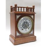 A circa 1890 oak mantel clock with gallery top, enamel "Fantasy" dial,