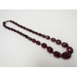 A facet cut cherry amber graduated bead necklace,