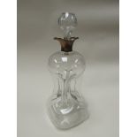 A glass decanter of hour glass form with silver pourer/collar,