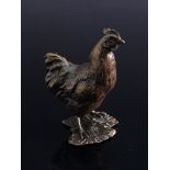 A miniature solid bronze chicken,