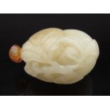 An 18th Century Chinese white jade snuff bottle carved as twin peaches with leaves and stems with