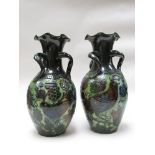 A pair of Barum green glaze vases with bird and flower design,