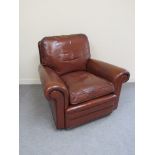 A pair of 20th Century leather club armchairs with outswept scroll arms and feather filled cushions