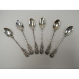 A set of six silver spoons with rose finials