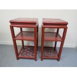 A near pair of early 20th Century red laquer Chinese urn stands