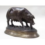 A cast metal figure of a pig bearing signature E.