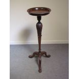 An early to mid 20th Century ornate mahogany jardiniere stand with paw feet,