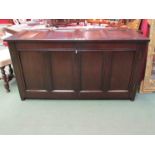 An 18th Century panelled oak coffer the hinged lid over two doors on stile feet,