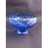 A blue crystal glass footed bowl with star cut base and thumb nail edge,