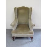 A late Victorian walnut wing back armchair,