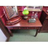 An Edwardian mahogany writing desk with twin drawer on melon fluted legs,