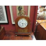 A Victorian mantel clock of domed form with ring drop handles,