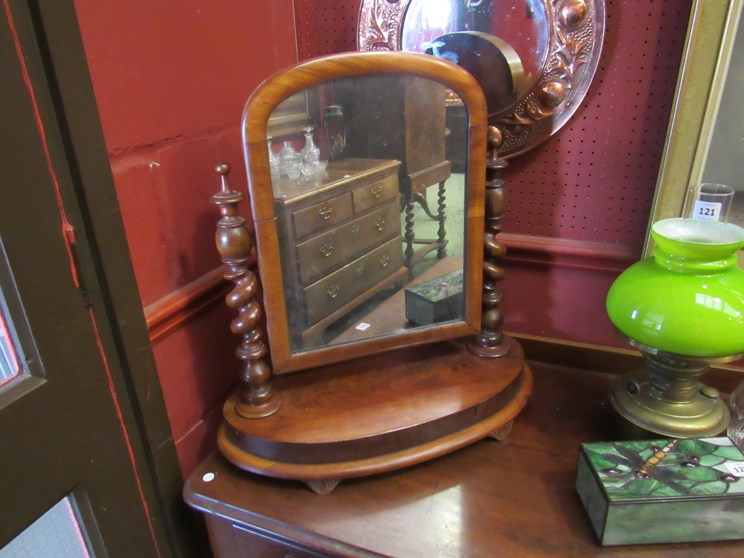 A Victorian mahogany toilet mirror with barley twist supports, finial embellishment,
