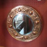 A Keswick school of Industrial Art, copper mirror with bevelled glass, rounded and leaf border 41.