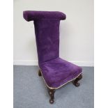 An Edwardian mahogany prayer chair with purple velvet upholstery on front cabriole legs