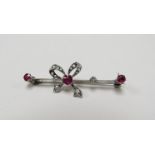 A diamond and ruby set "bow" bar brooch