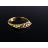 An 18ct gold five stone diamond ring (one stone replaced - not diamond)