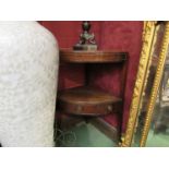 A Victorian mahogany two tier corner washstand with central drawer flanked by twin faux drawers