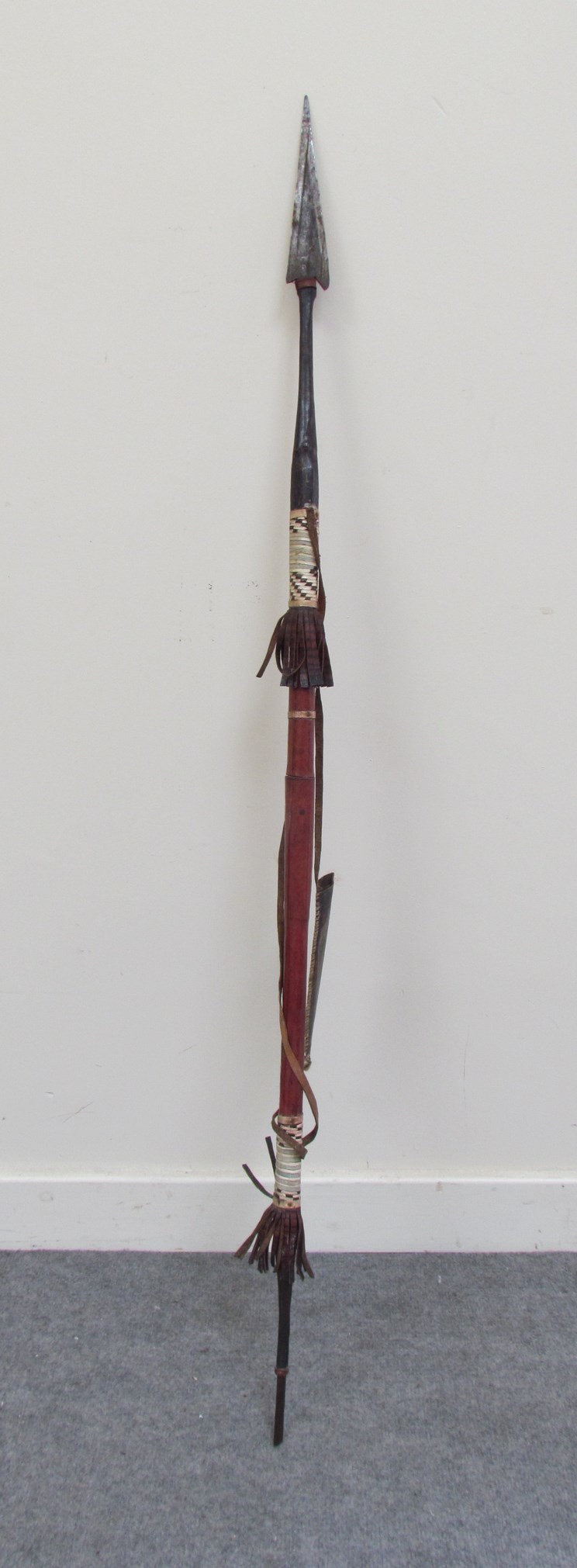 An African spear with leather covered shaft and scabbard