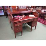 An Edwardian tamber top writing desk with single drawer flanked by two drawers,