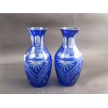 A pair of cut glass vases with blue overlay,