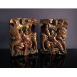 A pair of Oriental wooden fixtures each carved in one piece and depicting two men and a horse,