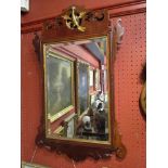 A 19th Century walnut wall hanging mirror with ho-ho bird detail, bevelled glass,