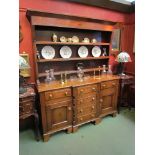 A 19th Century oak break front dresser, four central drawers flanked by cupboards and drawers,