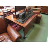 A George III flame mahogany drop leaf dining table on cabriole legs with claw in ball feet
