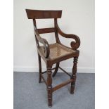 A Victorian mahogany child's high chair with cane seat,