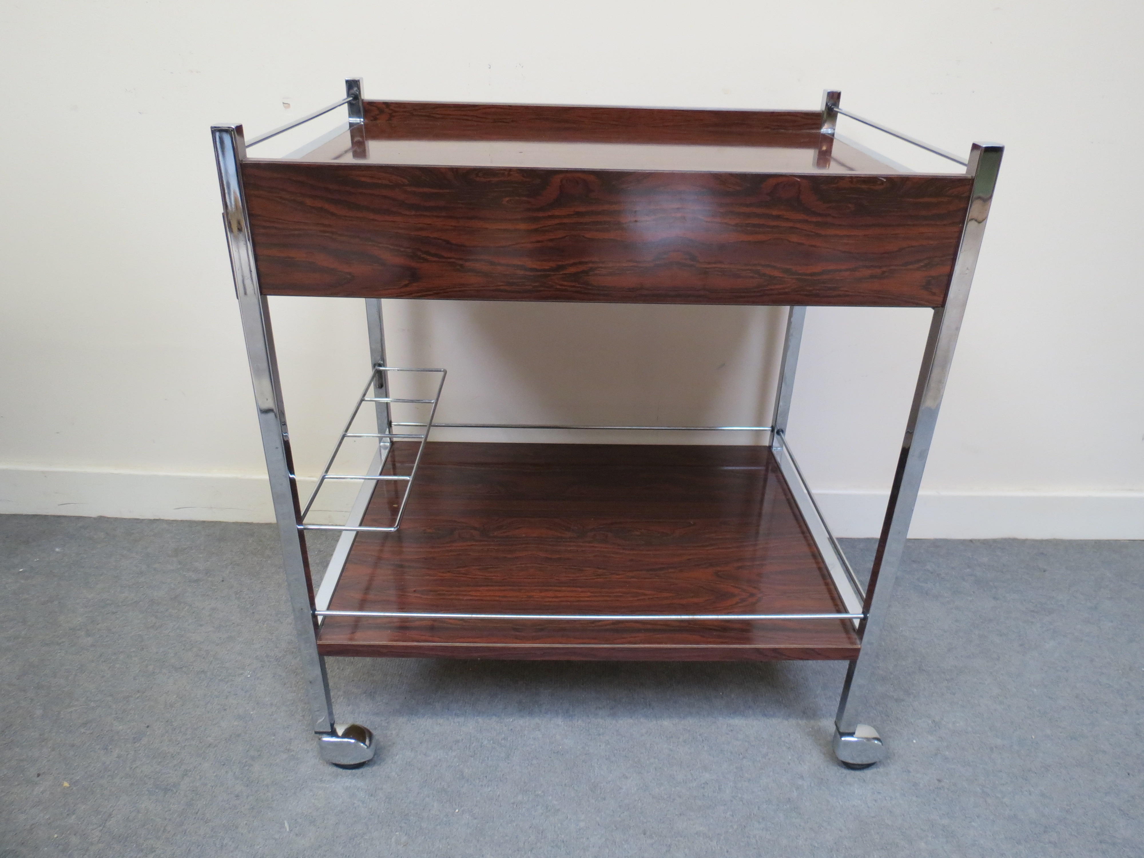 A 1970's chrome and formica two tier drinks trolley with pull-out warming tray