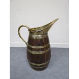 An oak and brass bound barrel form jug,