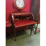An Edwardian mahogany cylinder desk with fitted pigeon hole and drawer interior,