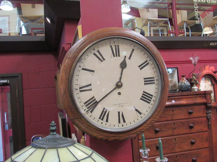 An oak cased dial clock with painted Roman dial signed John Smith & Son,