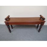 A Victorian mahogany window seat/bench with turned scroll ends,