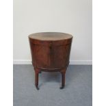 A George III mahogany ebony inlaid oval wine cooler, zinc lined with base tap,