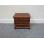 A Georgian style walnut miniature chest.