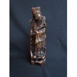 A Chinese carved hardwood figure of an immortal, with inlaid wirework of foliate design. 34.