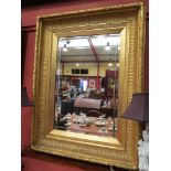 A 19th Century gilt gesso framed mirror with acanthus leaf and berry patterned frame,