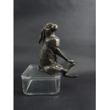 A bronzed figure of a shelf sitting hare