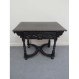 An 18th Century oak side table with carved decoration, the single frieze drawer,