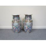 A pair of Cantonese style vases of large proportions depicting panels of interior scenes with