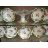 A Victorian dessert service, white ground with green panels, enriched with gilt scrolls,