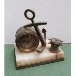 A novelty brass and onyx clock, thermometer and compass in the form of a barrel and anchor,