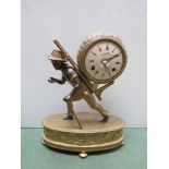 A brass figural clock surmounted by a figure of a working boy carrying load,