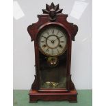 An American mahogany and carved "gingerbread" style mantel clock with Roman dial and 8 day movement,